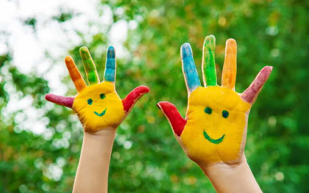 Colorful painted hands with a smiley face