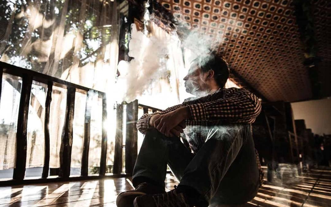 Young man using smoking alternative